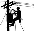 Lineman working on power lines in silhouette Royalty Free Stock Photo