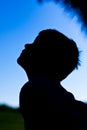 Silhouette of little boy against blue sky Royalty Free Stock Photo