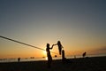 Silhouette of little girl balancing on slackline Royalty Free Stock Photo