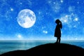 Silhouette, little girl child standing on a hill by the sea looking at the starry sky. Royalty Free Stock Photo