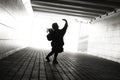 Silhouette of a little girl with flowers in the tunnel Royalty Free Stock Photo