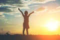 Silhouette of little girl raising hand to happy time Royalty Free Stock Photo