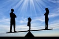 Silhouette little sad girl crying standing between mom and dad, chooses to stay with dad Royalty Free Stock Photo