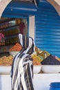 Moroccan local market with a stall of different types of olives and bottles of olive oil Royalty Free Stock Photo