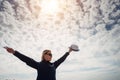 Silhouette of lonely happy traveler woman with open outstretched arms against beautiful cloudy sky. Freedom concept and enjoying Royalty Free Stock Photo