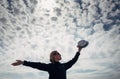 Silhouette of lonely happy traveler woman with open outstretched arms against beautiful cloudy sky. Freedom concept and enjoying Royalty Free Stock Photo