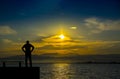 Silhouette, lonely man watching the sea at sunset