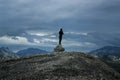 Silhouette of lonely Person standing on a Rock