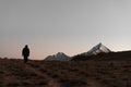 Silhouette of a lonely person walking in a valley