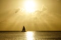 SILHOUETTE: Lonely sailboat sails across the ocean on a golden summer evening. Royalty Free Stock Photo