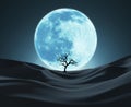 Silhouette of a Lonely Tree Against Big Blue Moon Royalty Free Stock Photo
