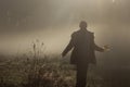 Silhouette Of Lonely Walker In Misty Autumn Morning