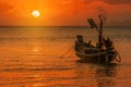 Silhouette longtail boat fishingboat moored on tropical beach  at fisherman village during sunset twilight time Royalty Free Stock Photo