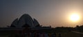 Silhouette of Lotus Temple during sunset with many unknown tourists. Landscape shot.