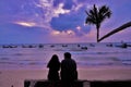 Silhouette love couple watching sunset on the beach Royalty Free Stock Photo