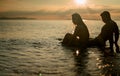 Silhouette love couple travel together on the beach with sunset view. Romantic and relaxing on summer