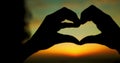 Silhouette, love and heart hand with sunset clouds background for peace and selflove girl. Woman calm, happy and relaxed