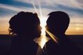 Silhouette of a loving couple kissing in the sunset Royalty Free Stock Photo