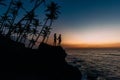 Silhouette of loving couple on sea. Man and woman at sunset. Honeymoon on the Islands. Man and woman meet sunset. Happy loving