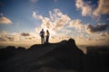 Silhouette of a loving couple at sunset. Man embracing with a woman on a high mountain overlooking the sea. Concept Royalty Free Stock Photo