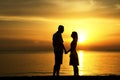 Silhouette of a loving couple at sunset on the seashore Royalty Free Stock Photo