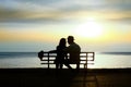 Silhouette of a loving couple at sunset on the seashore Royalty Free Stock Photo