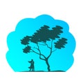 Silhouette of a loving couple in a tight hug near a deciduous tree