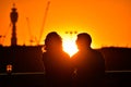 Silhouette of loving couple watching beautiful bright romantic sunset Royalty Free Stock Photo