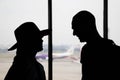 Silhouette of loving couple watching flight at airport