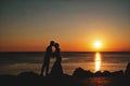 Silhouette of a loving, married couple where he is kissing her h Royalty Free Stock Photo