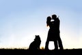 Silhouette of Loving Young Couple Hugging at Sunset Outside Royalty Free Stock Photo