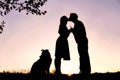 Silhouette of Loving Young Couple Kissing Under Tree at Sunset Royalty Free Stock Photo