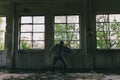 Silhouette of male caucasian hip hop dancer, freestyling outdoors in an old abandoned building Royalty Free Stock Photo