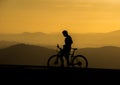 Silhouette of a male cyclist on sunset