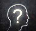 Silhouette of a male face with a glowing question