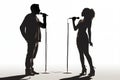 Silhouette of a male and female vocalists singing with microphones Royalty Free Stock Photo