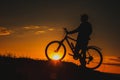 Silhouette of a male mountainbiker at sunset in the mountains Royalty Free Stock Photo