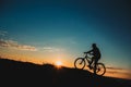 Silhouette of a male mountainbiker at sunset in the mountains Royalty Free Stock Photo