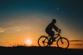 Silhouette of a male mountainbiker at sunset in the mountains Royalty Free Stock Photo