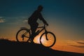 Silhouette of a male mountainbiker at sunset in the mountains Royalty Free Stock Photo