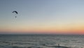 Silhouette of a male paraglider on a paraplan with motor over sea