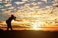 Silhouette of male photographer taking picture against sunset Royalty Free Stock Photo