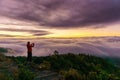 Silhouette of male photographer or traveler taking a photograph sunrise landscape on mountain top at Doi Inthanon National Park Royalty Free Stock Photo