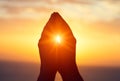 Silhouette of male raising hands praying for God`s blessings at sunset or sunrise light