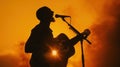 silhouette of a male singer playing guitar at sunset Royalty Free Stock Photo