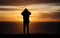 Silhouette of a man at against a dramatic cloudy sky at sunset Royalty Free Stock Photo