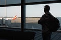 Silhouette of a man in airport lounge while waiting for plane departure Royalty Free Stock Photo