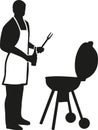 Silhouette of man with apron barbecuing