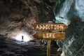 Silhouette of Man with arms up at the exit of a tunnel successful in beating addiction and choosing life. Conceptual image