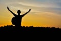 Silhouette of man with backpack open hand on the sky sunset back Royalty Free Stock Photo